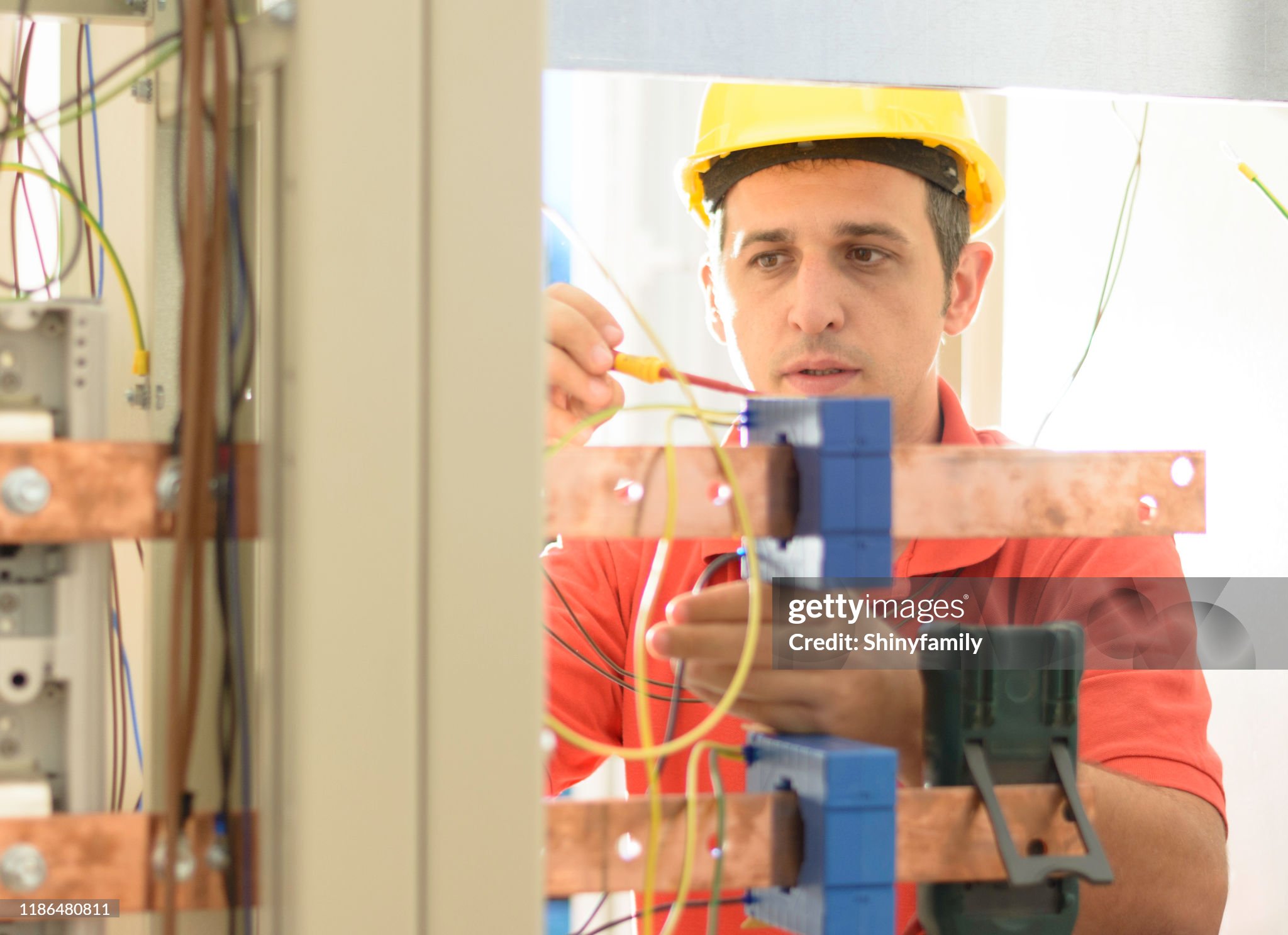 Engineer inspecting cabling connection in electrical room