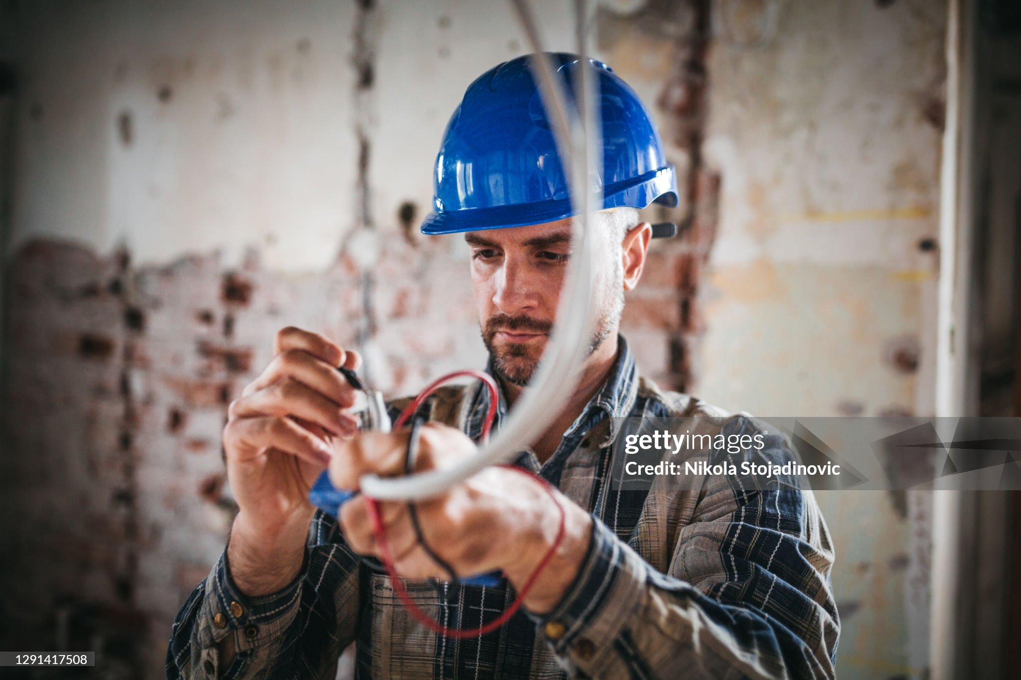 An electrical engineer connects the electricity