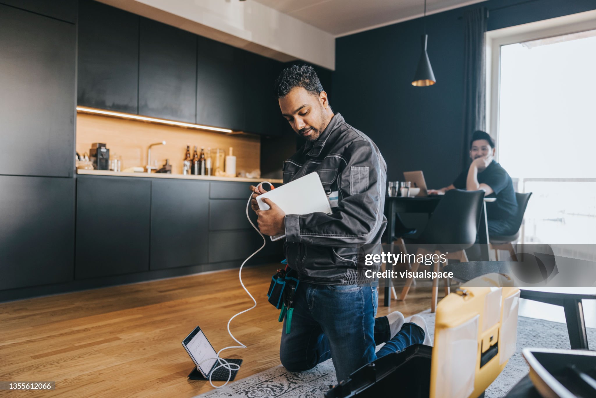 Indian technician installing wifi router at customers house.